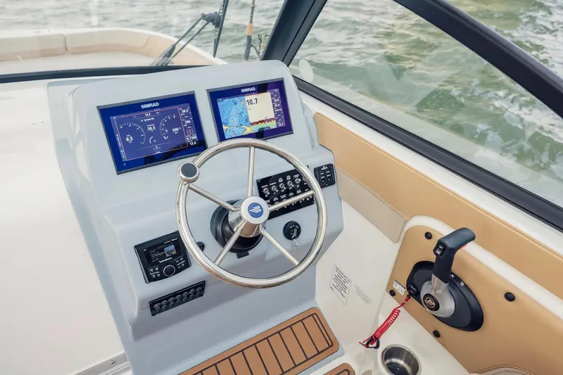 Slide: The Image of Manufacturer Provided Image: 2025 Bayliner Trophy T22SC helm with dual Simrad displays and steering wheel. - 3