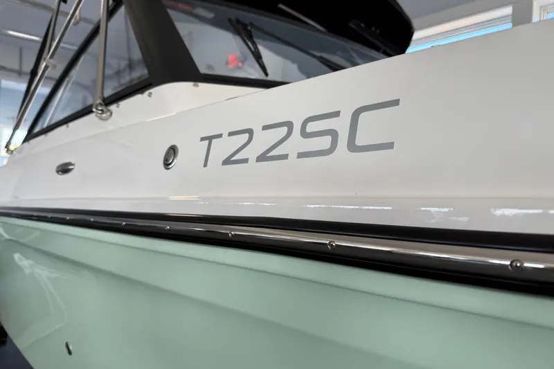 Slide: The Image of 2025 Bayliner Trophy T22SC boat side view with model name displayed. - 8
