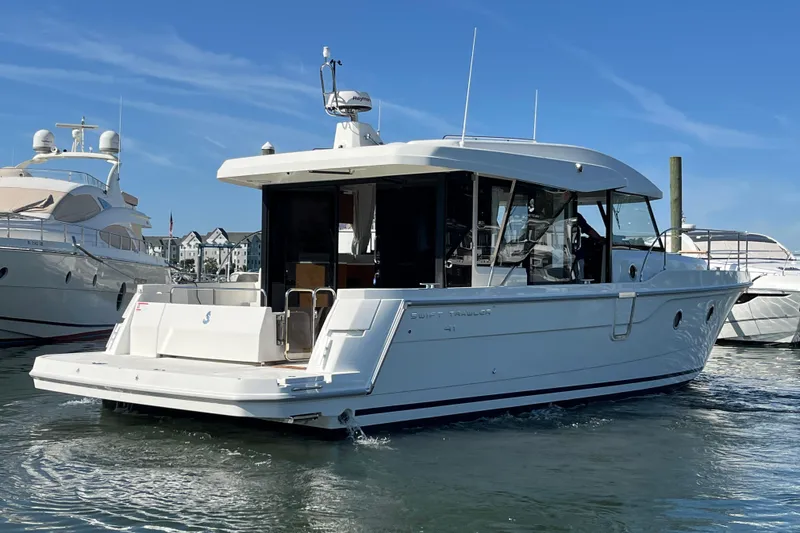 Slide: The Image of 2026 Beneteau 41 Swift Trawler Sedan in marina, sleek design, sunny day. - 10