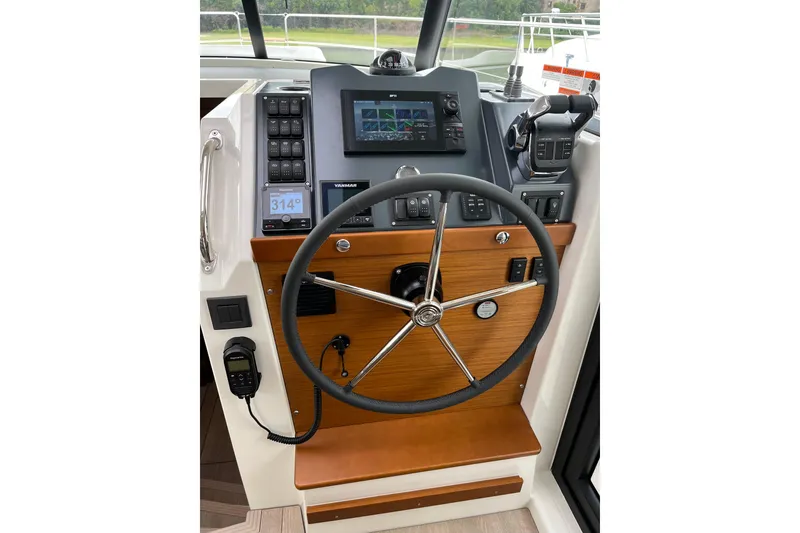 Slide: The Image of Helm of 2026 Beneteau 41 Swift Trawler Sedan with modern navigation controls. - 14
