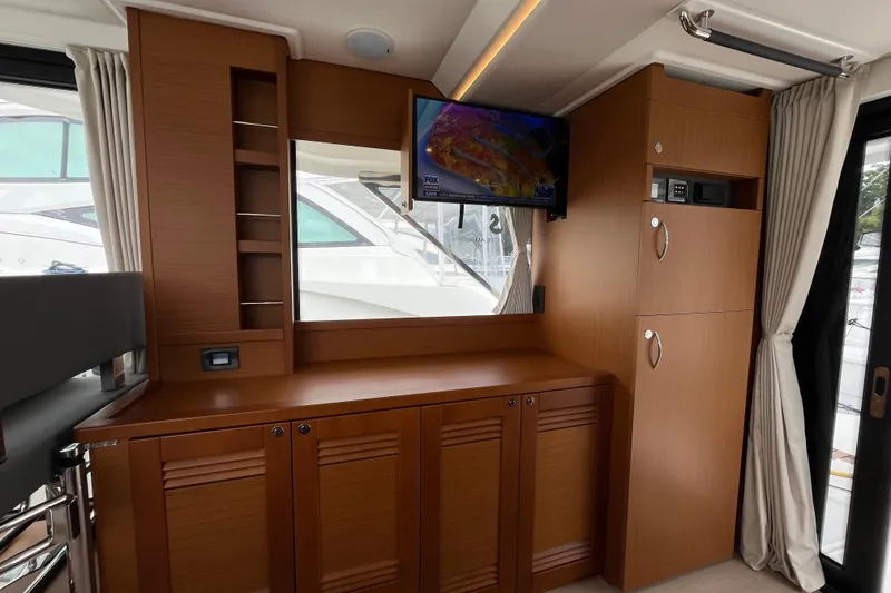 Slide: The Image of Interior of 2026 Beneteau 41 Swift Trawler Sedan with wood cabinetry and mounted TV. - 17