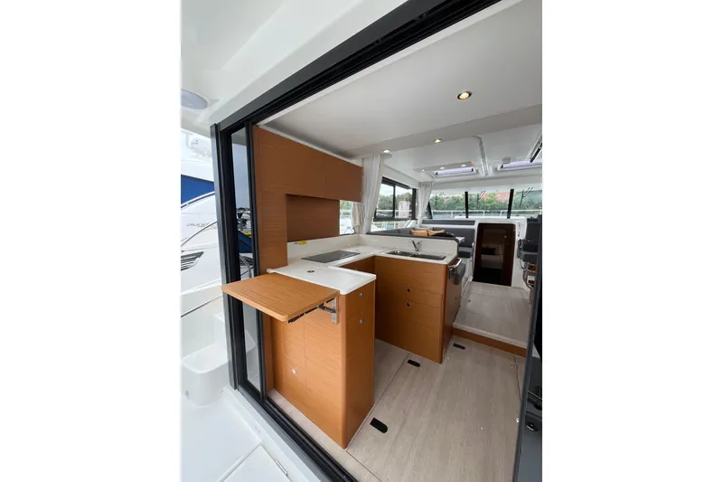 Slide: The Image of Interior of 2026 Beneteau 41 Swift Trawler Sedan, featuring modern kitchen and seating area. - 18