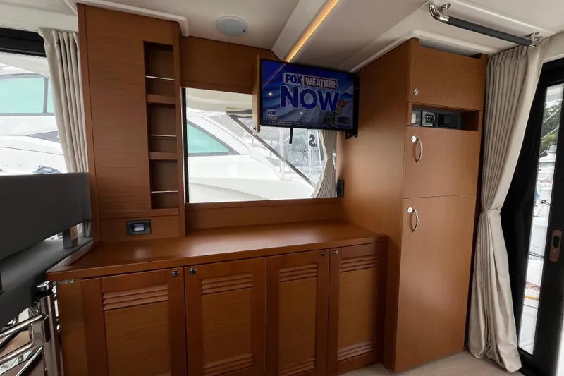 Slide: The Image of Interior of 2026 Beneteau 41 Swift Trawler Sedan with TV and wooden cabinetry. - 23