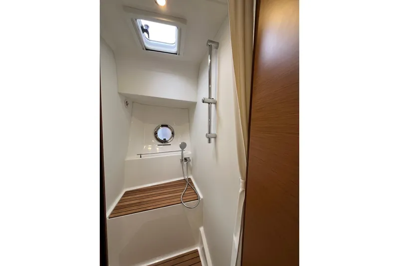 Slide: The Image of Shower area in 2026 Beneteau 41 Swift Trawler Sedan with wooden flooring and porthole. - 28