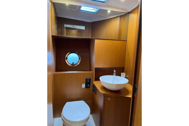 Slide: The Image of 2026 Beneteau 41 Swift Trawler Sedan bathroom with modern fixtures and wood finish. - 29