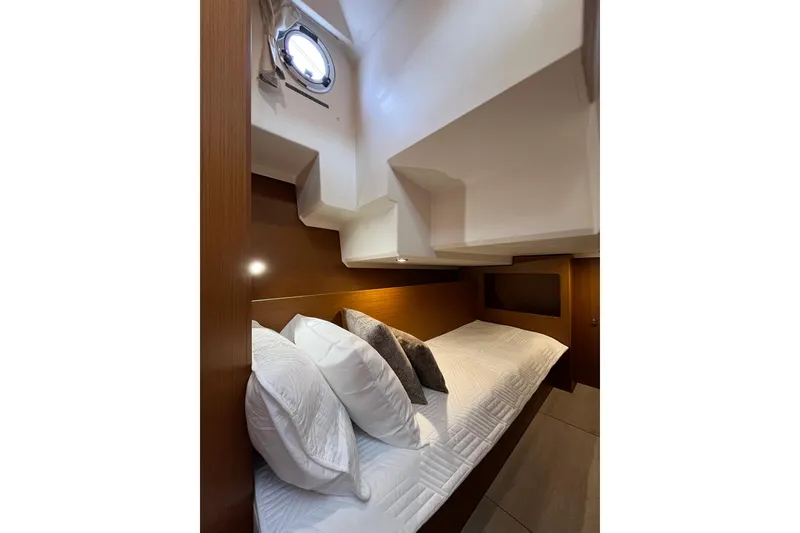 Slide: The Image of Cozy cabin interior of 2026 Beneteau 41 Swift Trawler Sedan with plush bedding. - 34