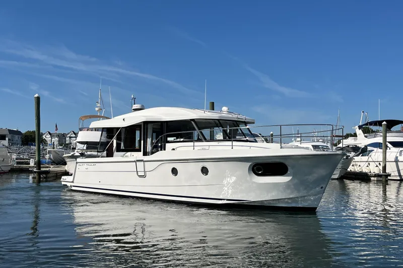 Slide: The Image of 2026 Beneteau 41 Swift Trawler Sedan in marina, clear sky background. - 6