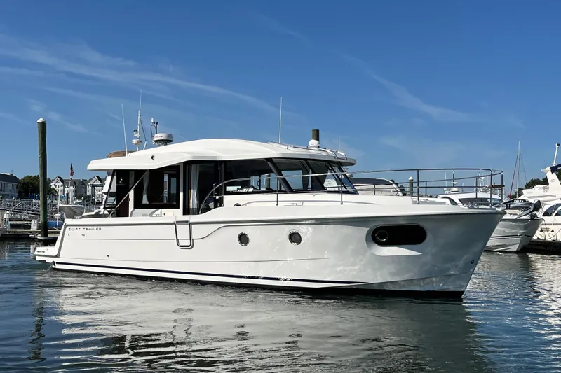 Slide: The Image of 2026 Beneteau 41 Swift Trawler Sedan in marina, clear sky background. - 7