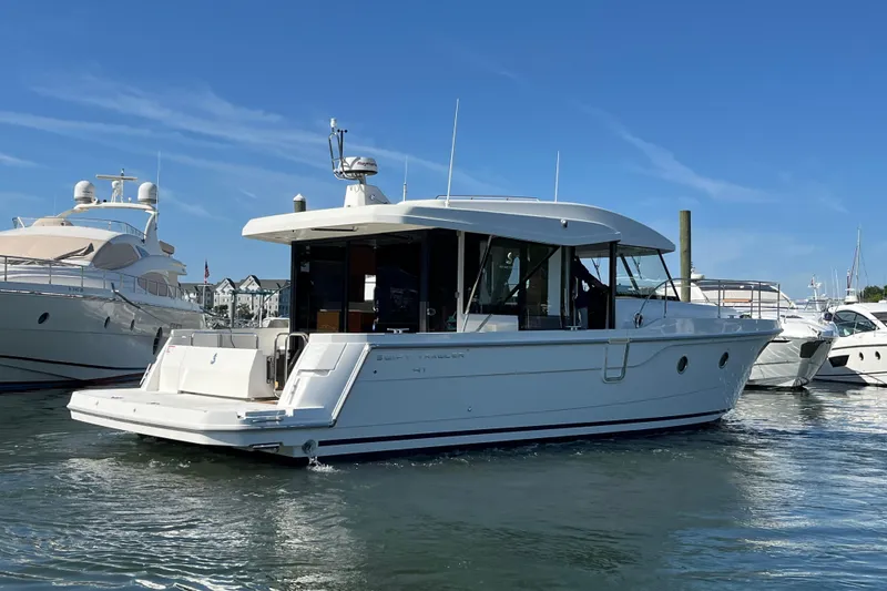 Slide: The Image of 2026 Beneteau 41 Swift Trawler Sedan in marina, clear blue sky background. - 9