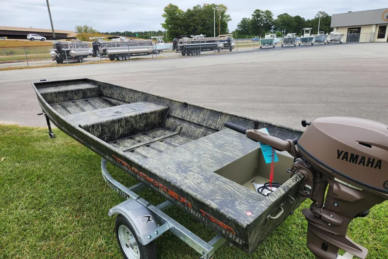 Slide: The Image of 2026 Tracker Grizzly 15 Jon boat with Yamaha motor on a trailer, parked outdoors. - 10