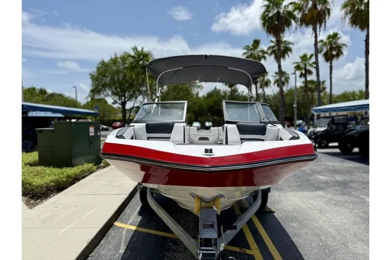 Slide: The Image of 2025 Yamaha Boats SX195 on trailer, parked under palm trees, sunny day. - 3