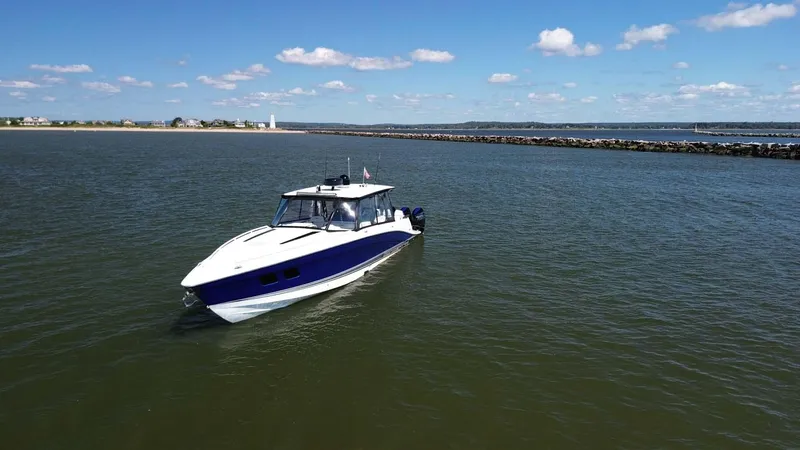 Slide: The Image of 2020 Concept 44' Cuddy Cabin boat cruising on calm waters under a clear blue sky. - 7