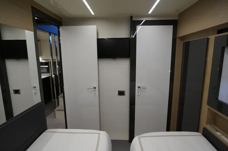 Slide: The Image of Interior of 2016 Pershing 70 yacht with modern design and twin beds. - 25