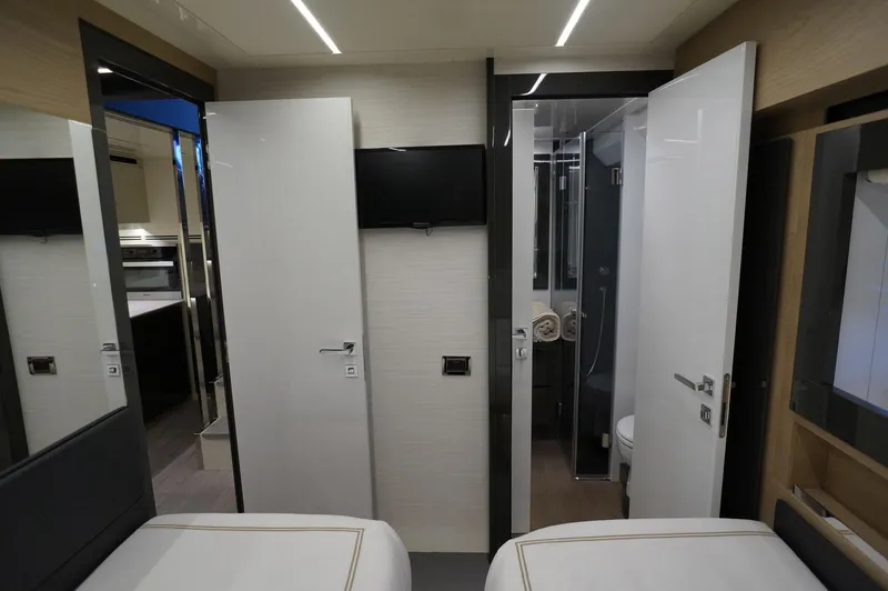 Slide: The Image of Interior of 2016 Pershing 70 yacht cabin with modern design and ensuite bathroom. - 26
