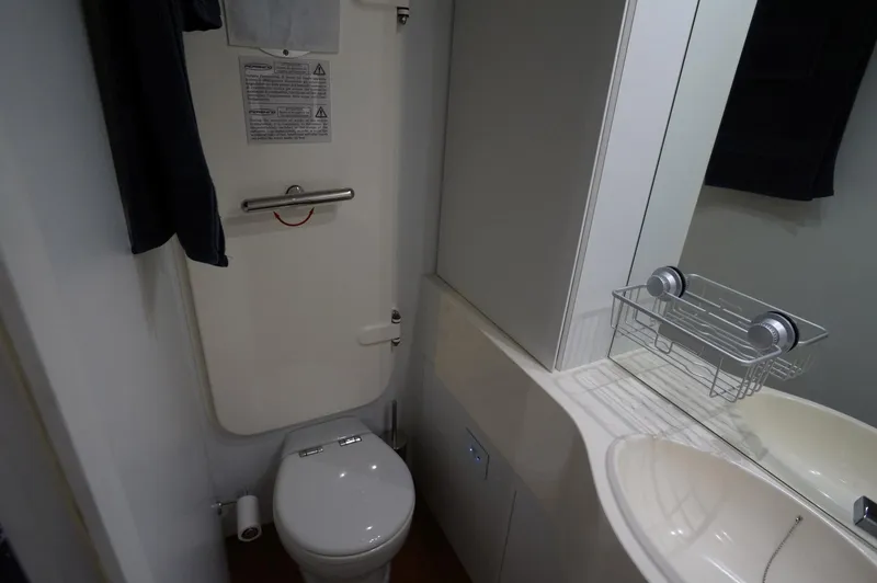 Slide: The Image of Bathroom interior of 2016 Pershing 70 yacht, featuring toilet and sink. - 27