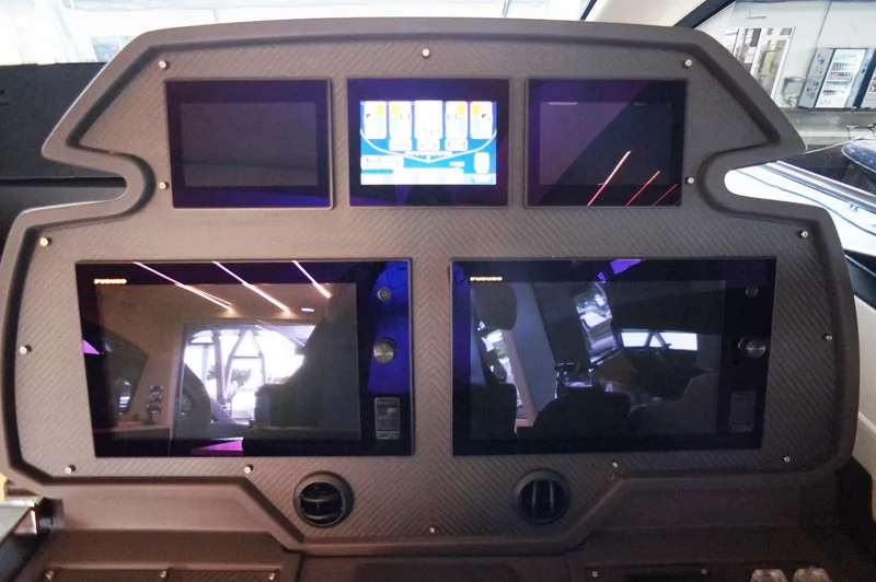 Slide: The Image of Control panel of a 2016 Pershing 70 yacht with multiple screens and modern design. - 3