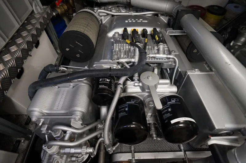 Slide: The Image of Engine compartment of a 2016 Pershing 70 yacht, showcasing intricate mechanical components. - 33