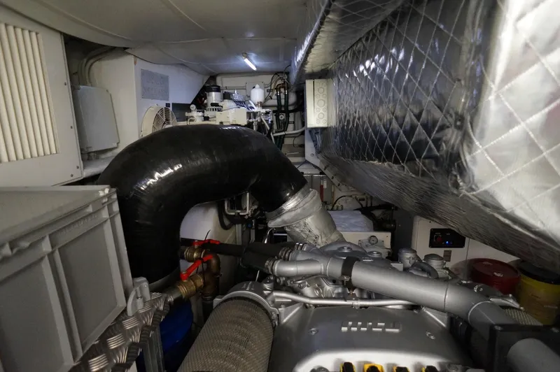 Slide: The Image of Engine room of a 2016 Pershing 70 yacht, showcasing mechanical components and ventilation systems. - 34