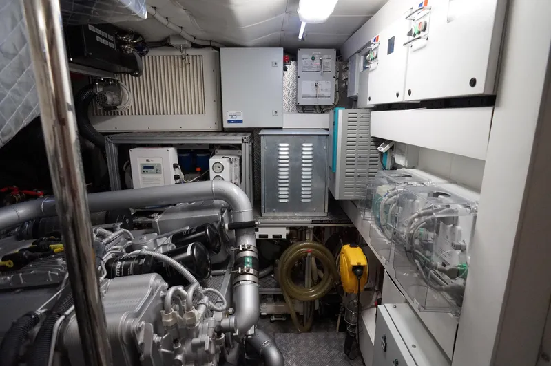 Slide: The Image of Engine room of a 2016 Pershing 70 yacht, showcasing machinery and equipment. - 35