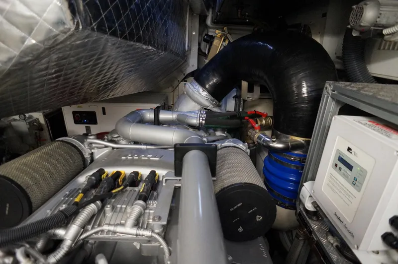 Slide: The Image of Engine room of 2016 Pershing 70 yacht, showcasing complex machinery and components. - 39