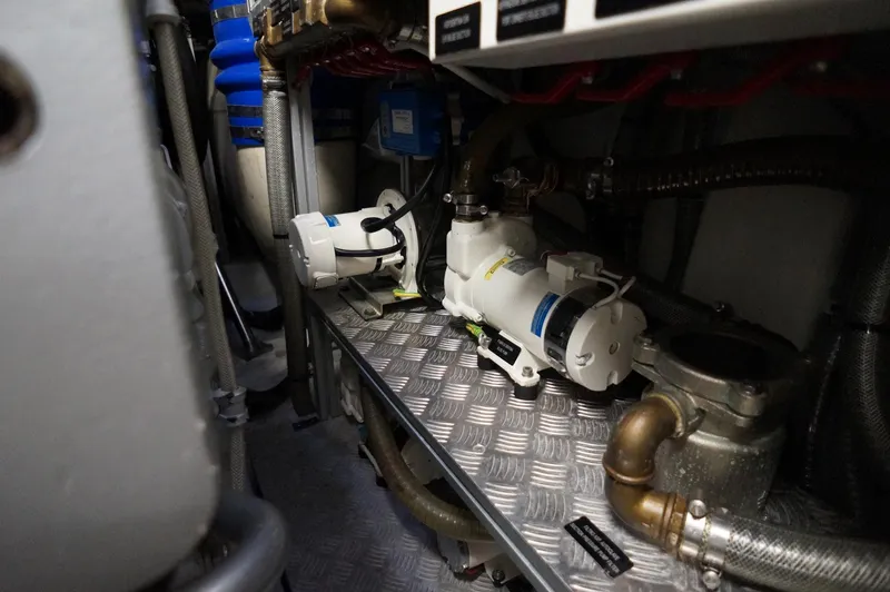 Slide: The Image of Engine room of 2016 Pershing 70 yacht, featuring mechanical components and piping. - 41
