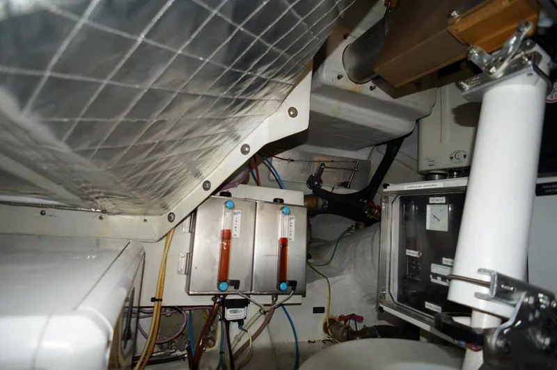 Slide: The Image of Engine room of 2016 Pershing 70 yacht, showcasing mechanical components and wiring. - 47