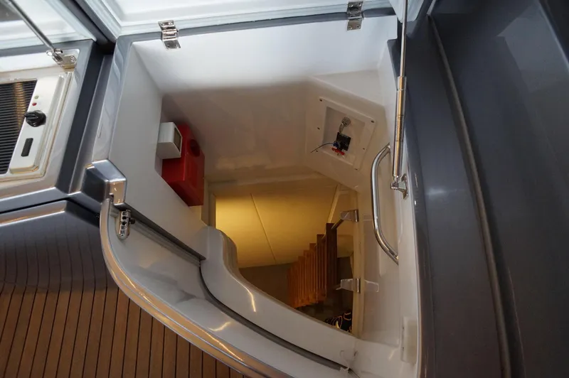 Slide: The Image of Staircase leading below deck on 2016 Pershing 70 yacht, featuring sleek design and modern finishes. - 6