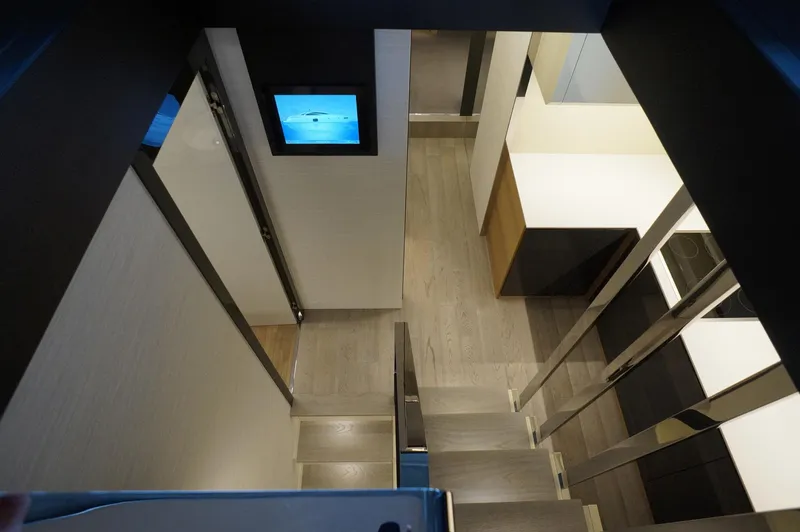 Slide: The Image of Interior view of 2016 Pershing 70 yacht, featuring modern stairs and sleek design elements. - 7