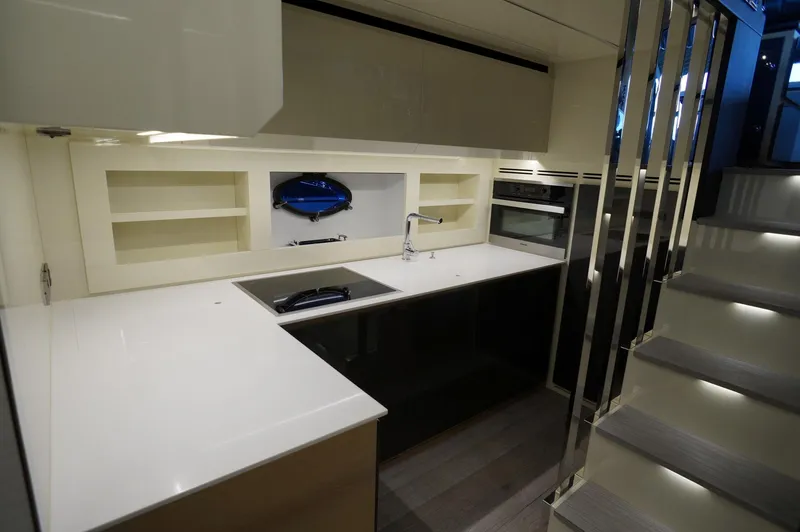 Slide: The Image of Modern kitchen interior on 2016 Pershing 70 yacht with sleek countertops and built-in appliances. - 8