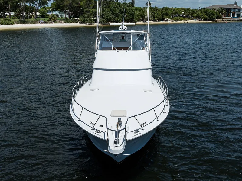 Slide: The Image of 2001 Hatteras 60 Convertible yacht on calm water, front view. - 42