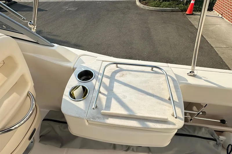 Slide: The Image of 2017 Grady White 235 boat interior with cup holders and storage compartment. - 10