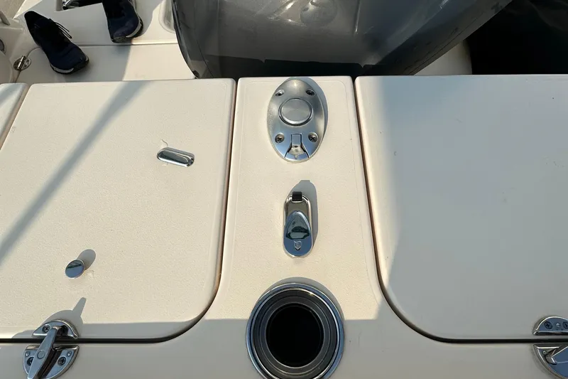 Slide: The Image of 2017 Grady White 235 boat deck with storage compartments and metal fixtures. - 11