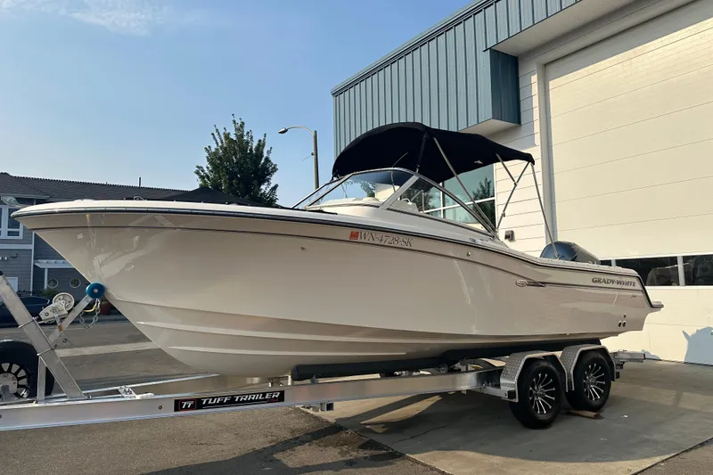 Slide: The Image of 2017 Grady White 235 boat on Tuff Trailer, parked outside a building. - 3