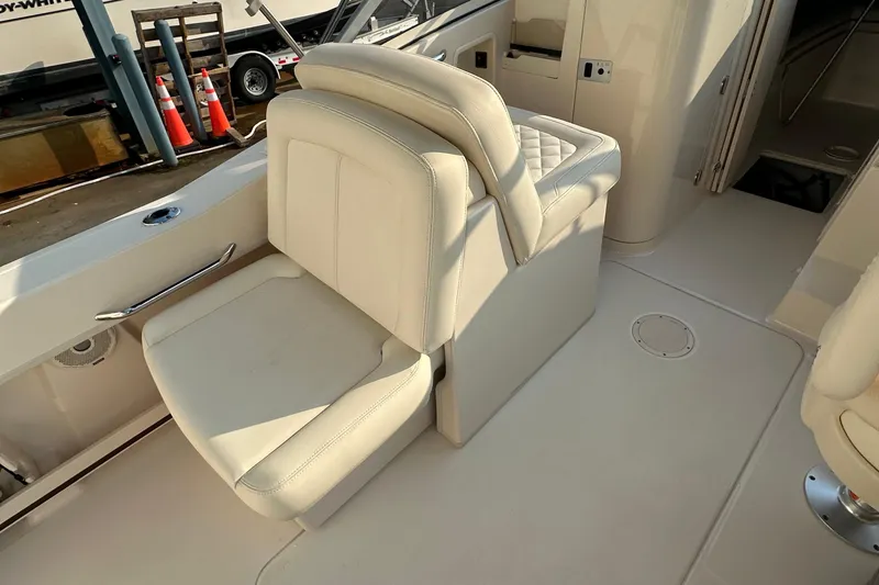 Slide: The Image of 2017 Grady White 235 boat interior with white cushioned seating. - 6