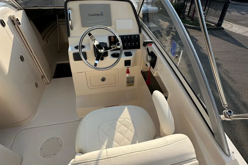 Slide: The Image of 2017 Grady White 235 boat cockpit with Garmin navigation system and steering wheel. - 7