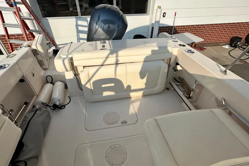 Slide: The Image of 2017 Grady White 235 boat interior with seating and engine view. - 9