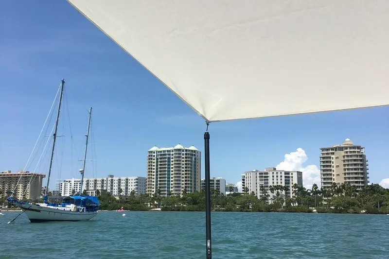 Slide: The Image of Coastal view from Grady-White Freedom 275 boat, 2012, with city skyline and sailboat. - 10