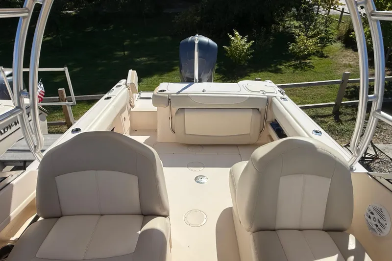 Slide: The Image of 2012 Grady-White Freedom 275 boat interior with seating and engine view. - 3