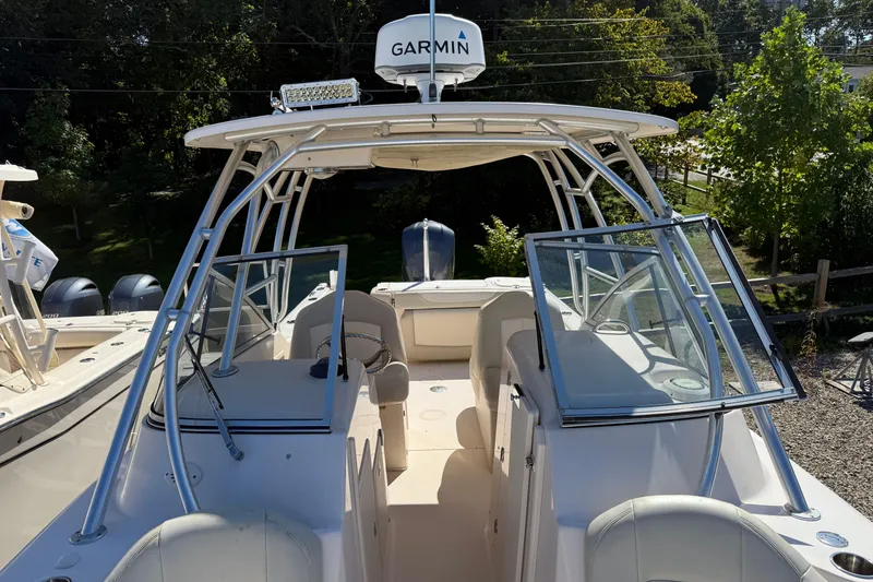 Slide: The Image of 2012 Grady-White Freedom 275 boat with Garmin equipment, docked outdoors. - 4