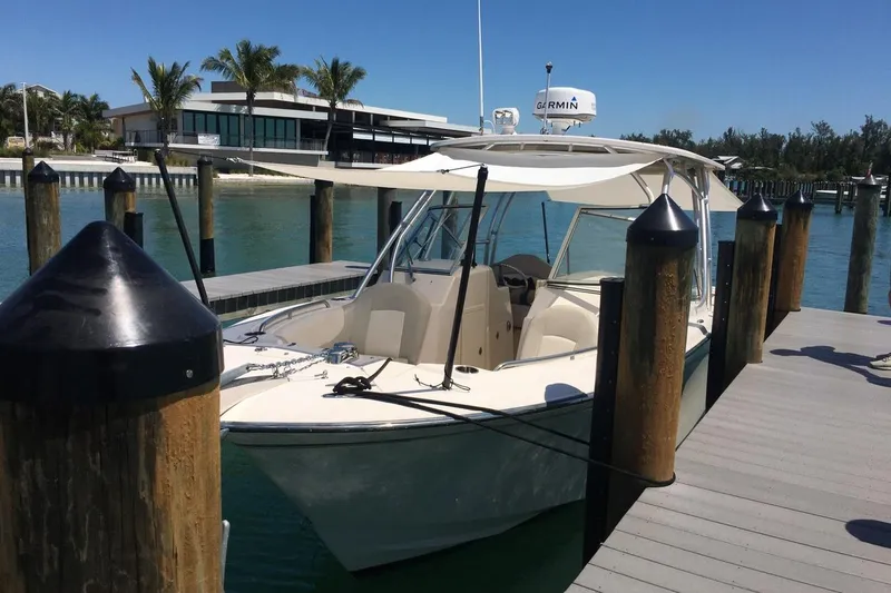 Slide: The Image of 2012 Grady-White Freedom 275 boat docked in sunny marina setting. - 7