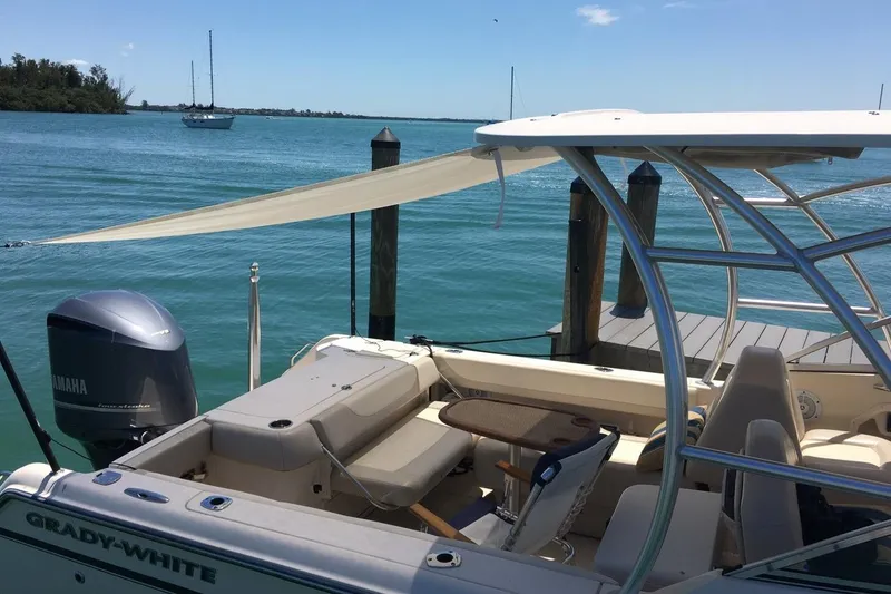 Slide: The Image of 2012 Grady-White Freedom 275 boat docked by serene blue waters. - 9