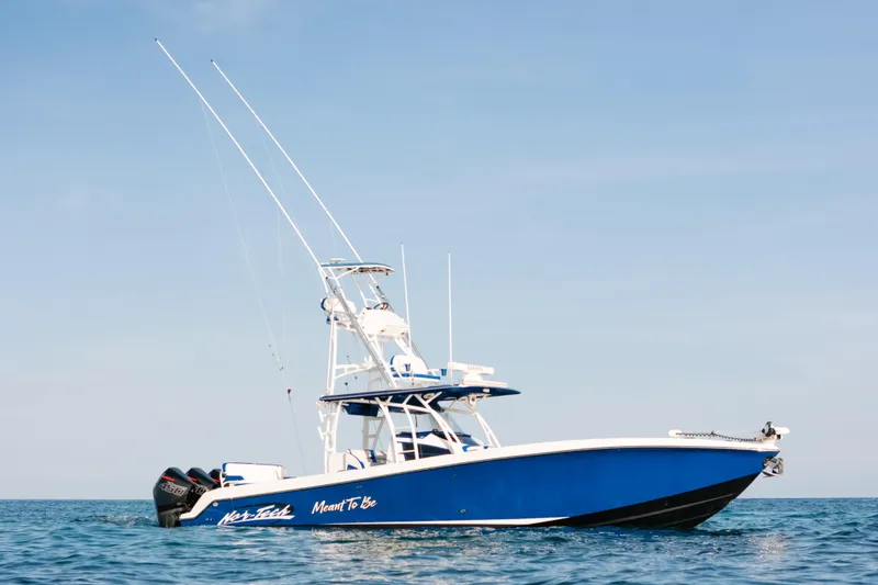 The Image of 2022 Nor-Tech 392 Super Fish boat on open water, blue and white design. - 1