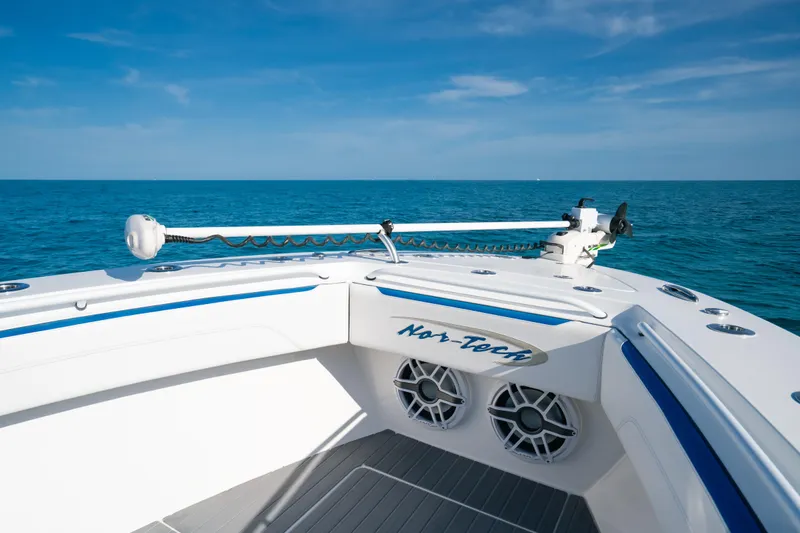 Slide: The Image of 2022 Nor-Tech 392 Super Fish boat on open sea, showcasing sleek design and advanced features. - 11