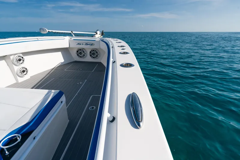 Slide: The Image of 2022 Nor-Tech 392 Super Fish boat on open ocean, showcasing sleek design and spacious deck. - 15