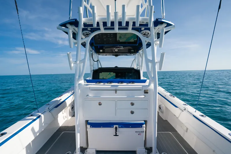 Slide: The Image of 2022 Nor-Tech 392 Super Fish boat interior with ocean view, featuring advanced navigation equipment. - 16