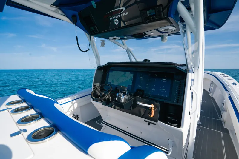 Slide: The Image of 2022 Nor-Tech 392 Super Fish boat interior with advanced navigation system and blue seating. - 17