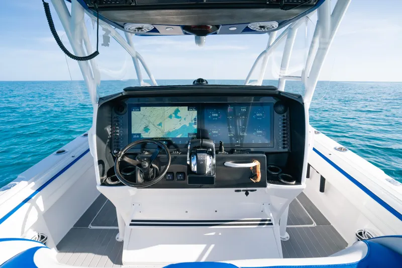 Slide: The Image of 2022 Nor-Tech 392 Super Fish boat dashboard with navigation screens on open sea. - 18