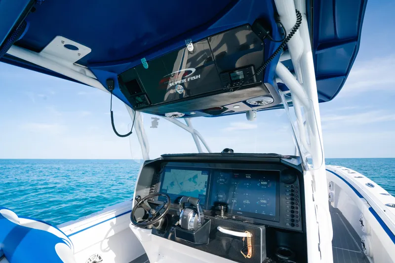 Slide: The Image of 2022 Nor-Tech 392 Super Fish boat dashboard with ocean view, featuring advanced navigation systems. - 21
