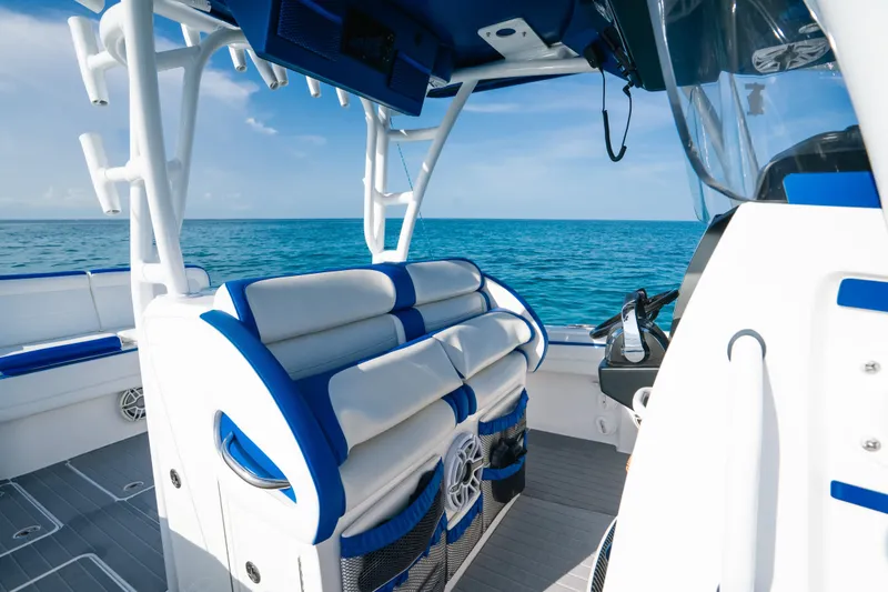 Slide: The Image of 2022 Nor-Tech 392 Super Fish boat interior with blue and white seating, ocean view. - 22