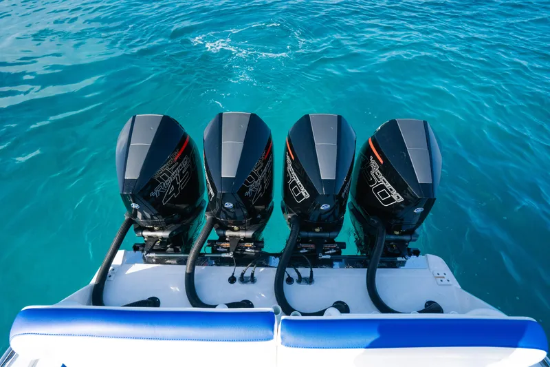 Slide: The Image of 2022 Nor-Tech 392 Super Fish boat with four powerful outboard engines on blue water. - 24